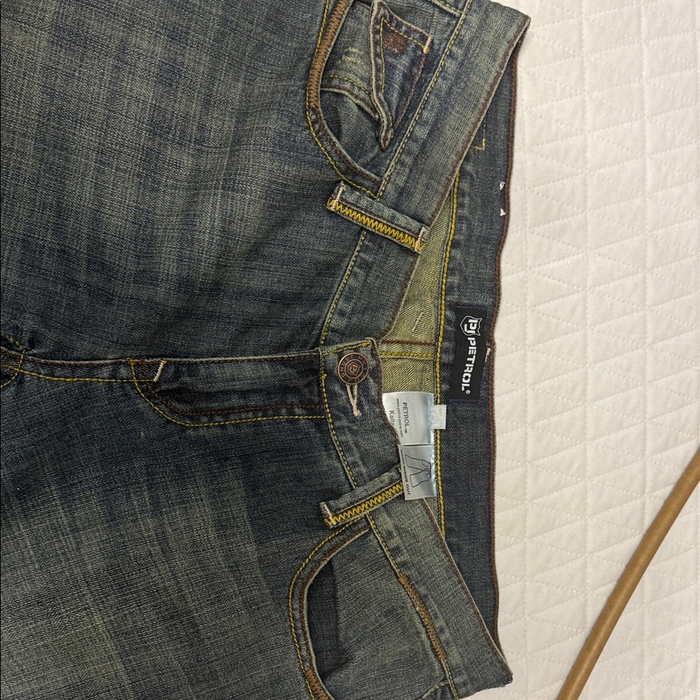 Petrol designer jeans with golden wash and studded back pockets